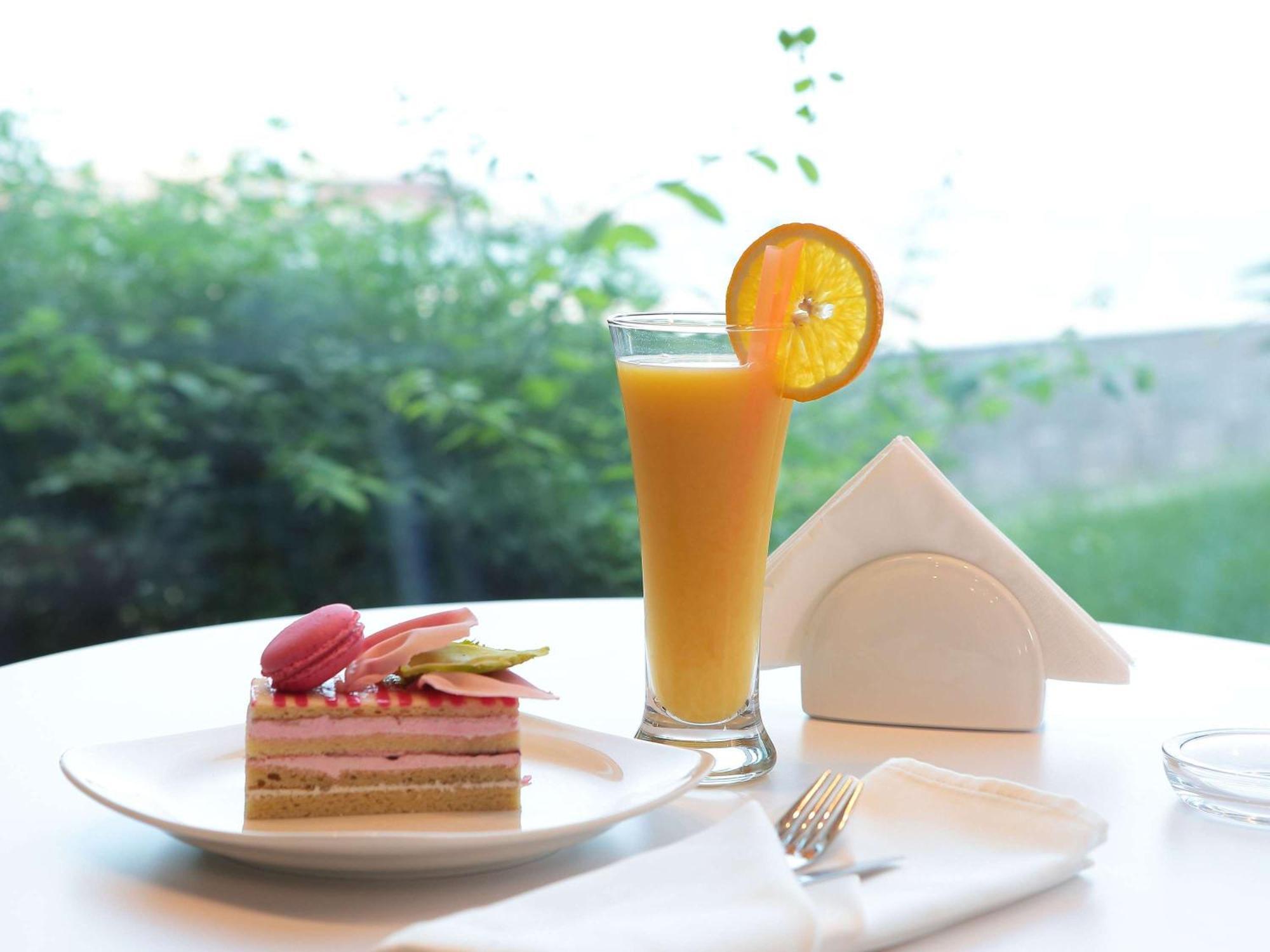 Novotel Jazan Exterior photo A glass of orange juice
